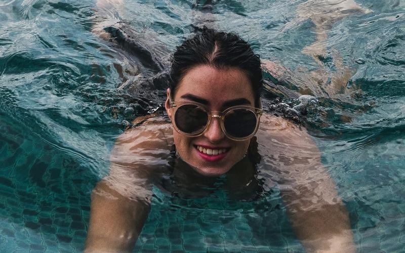 a woman wearing sunglasses in a pool